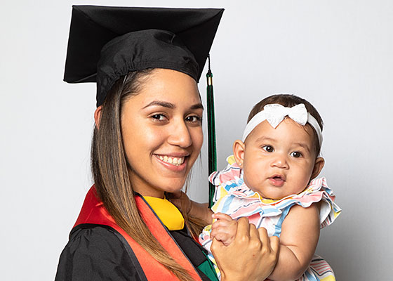 SEBS EOF student and her baby poses for graduation photo